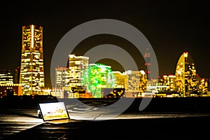 Yokohama night view and a laptop Nomad worker of the image