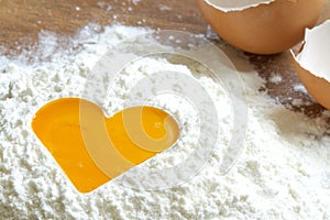 Yolk egg in flour love baking concept