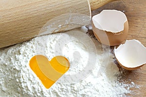 Yolk egg in flour love baking concept