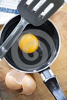 Yolk in pan with eggshell