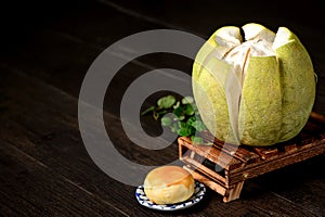 Yolk pastry egg yolk shortcake and peeled grapefruit on wooden table