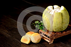 Yolk pastry egg yolk shortcake and peeled grapefruit on wooden table