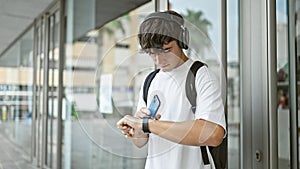 Yolo vibe, young mexican university student, hottie with a backpack, lost in music, clock-watchin\' in the campus streets