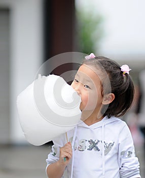 Yong girl eating cotton candy