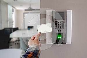 Yong man or woman use key card for access electronic door