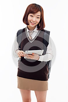 Yong pretty Asian student studying with tablet PC