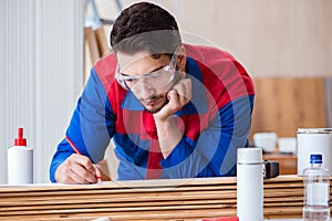 The yooung repairman carpenter working with paint painting