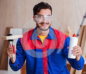 Yooung repairman carpenter working with paint painting