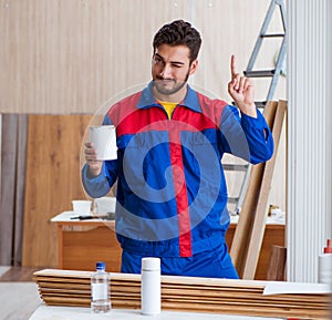 Yooung repairman carpenter working with paint painting