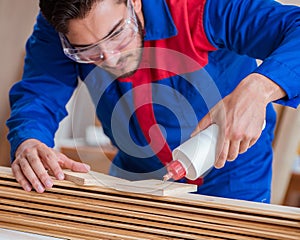 Yooung repairman carpenter working with paint painting