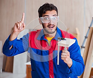 Yooung repairman carpenter working with paint painting