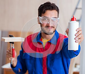 Yooung repairman carpenter working with paint painting