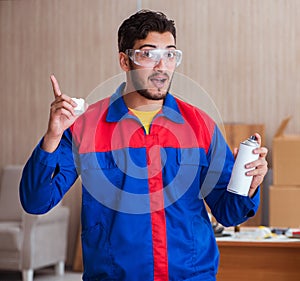 Yooung repairman carpenter working with paint painting