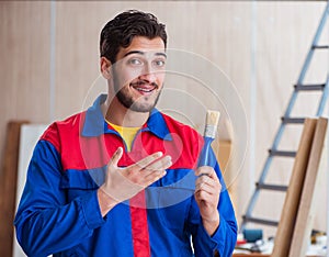 Yooung repairman carpenter working with paint painting