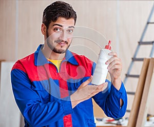 Yooung repairman carpenter working with paint painting