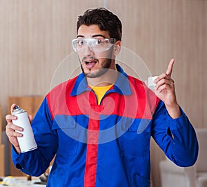 Yooung repairman carpenter working with paint painting