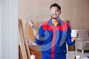 The yooung repairman carpenter working with paint painting