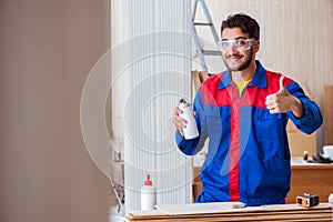 The yooung repairman carpenter working with paint painting