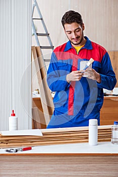 The yooung repairman carpenter working with paint painting