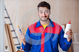 The yooung repairman carpenter working with paint painting