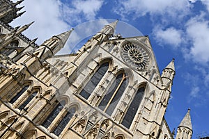 York Minster South façade with blue sky and clouds background