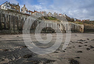 Yorkshire, England, Robin Hood`s Bay - a sandy beach and some houses..