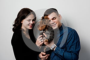 Yorkshire terrier with lovely couple on white background. Happy family with dog. Love to pets