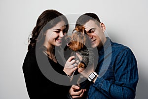 Yorkshire terrier with lovely couple on white background. Happy family with dog. Love to pets