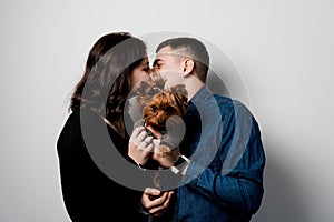 Yorkshire terrier with lovely couple on white background. Happy family with dog. Love to pets