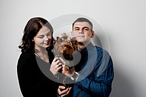 Yorkshire terrier with lovely couple on white background. Happy family with dog. Love to pets