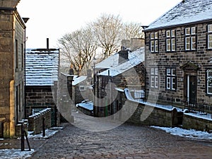 Yorkshire village of heptonstall in winter with snow covered roofs and street