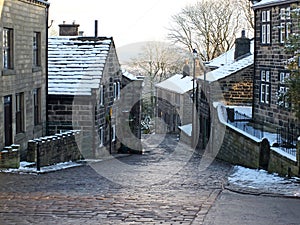 The yorkshire village of heptonstall in winter with snow covered roofs and street