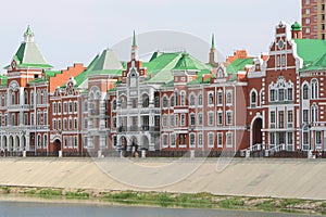 Yoshkar-Ola, Republic of Mari El, Russia - 08.20.2021. Buildings on the embankment of the Malaya Kokshaga River