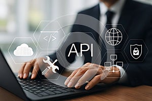 API Integration and Development Concept with Security and Cloud Computing Icons on Businessman's Laptop