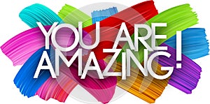 You are amazing paper word sign with colorful spectrum paint brush strokes over white