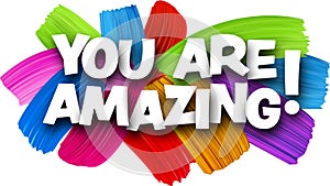 You are amazing paper word sign with colorful spectrum paint brush strokes over white