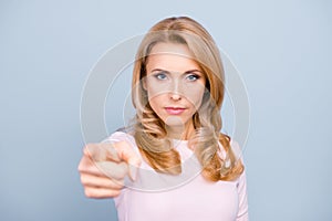 You annoy me! Close up portrait of serious strict aggressive nervous stressed woman pointing on camera isolated on gray background