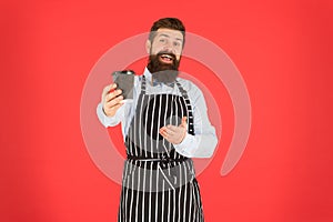 This is for you. bearded man hold take away coffee. brutal waiter in cafe. mature man red background. skilled servant
