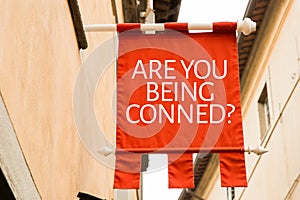 Are You Being Conned? on a conceptual image