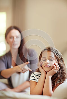You better listen to me. a young girl being reprimanded by her mother at home.