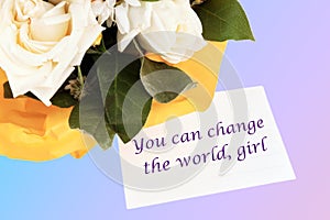 You can change the world, girl text written on a white business card on a colored background
