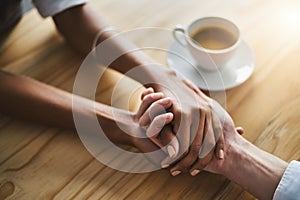 You can confide anything with me. Closeup shot of two people holding hands in comfort. photo