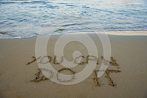 You can do it. Motivational inspirational message concept written on the sand of beach.