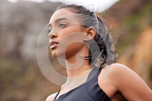 You can do it out your MIND into it. Shot of a fit young woman catching her breathe while completing her jog outdoors.