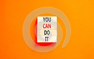 You can do it symbol. Concept word You can do it on beautiful wooden block. Beautiful orange table orange background. Business