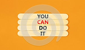 You can do it symbol. Concept word You can do it on beautiful wooden stick. Beautiful orange table orange background. Business