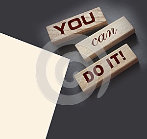 YOU CAN DO IT word on wooden blocks on gray background. Motivation affirmation encouraging words for personal achievements concept