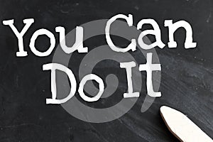 YOU CAN DO IT words written in chalk on a black blackboard