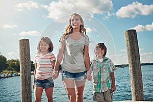 You can never waste time when spending it with family. a young family on a pier while out by the lake.