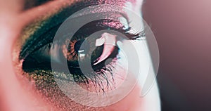 You can see the fire burning through her eyes. Closeup shot of a beautiful young womans eye against a dark background.